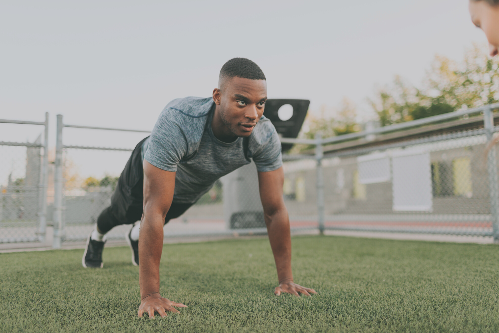 Athletic Man Doing Push Up in the Field